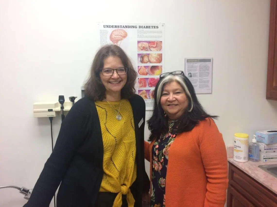 two ladies smiling in examination room