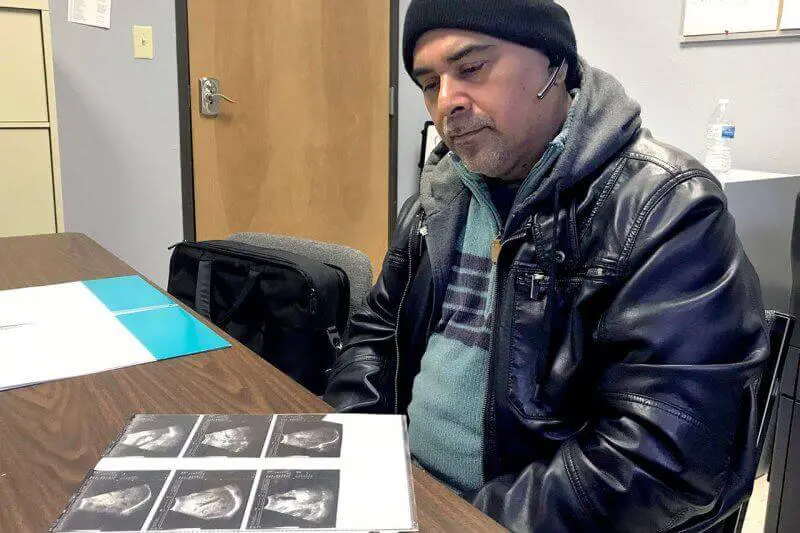 man looking at xrays