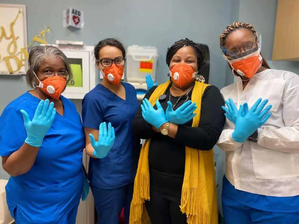51252043384_5174876386_o 4 women posing with masks and gloves