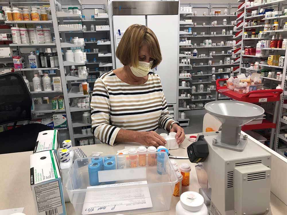 pharmacist putting together perscriptions